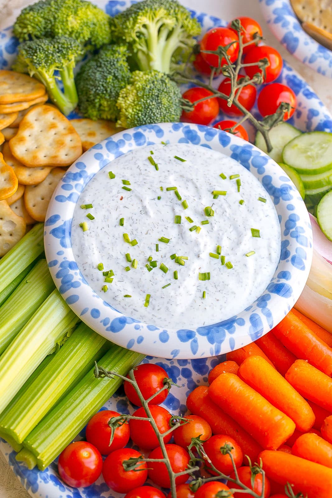 A big platter of veggies and crackers with the best Greek yogurt ranch dip recipe.