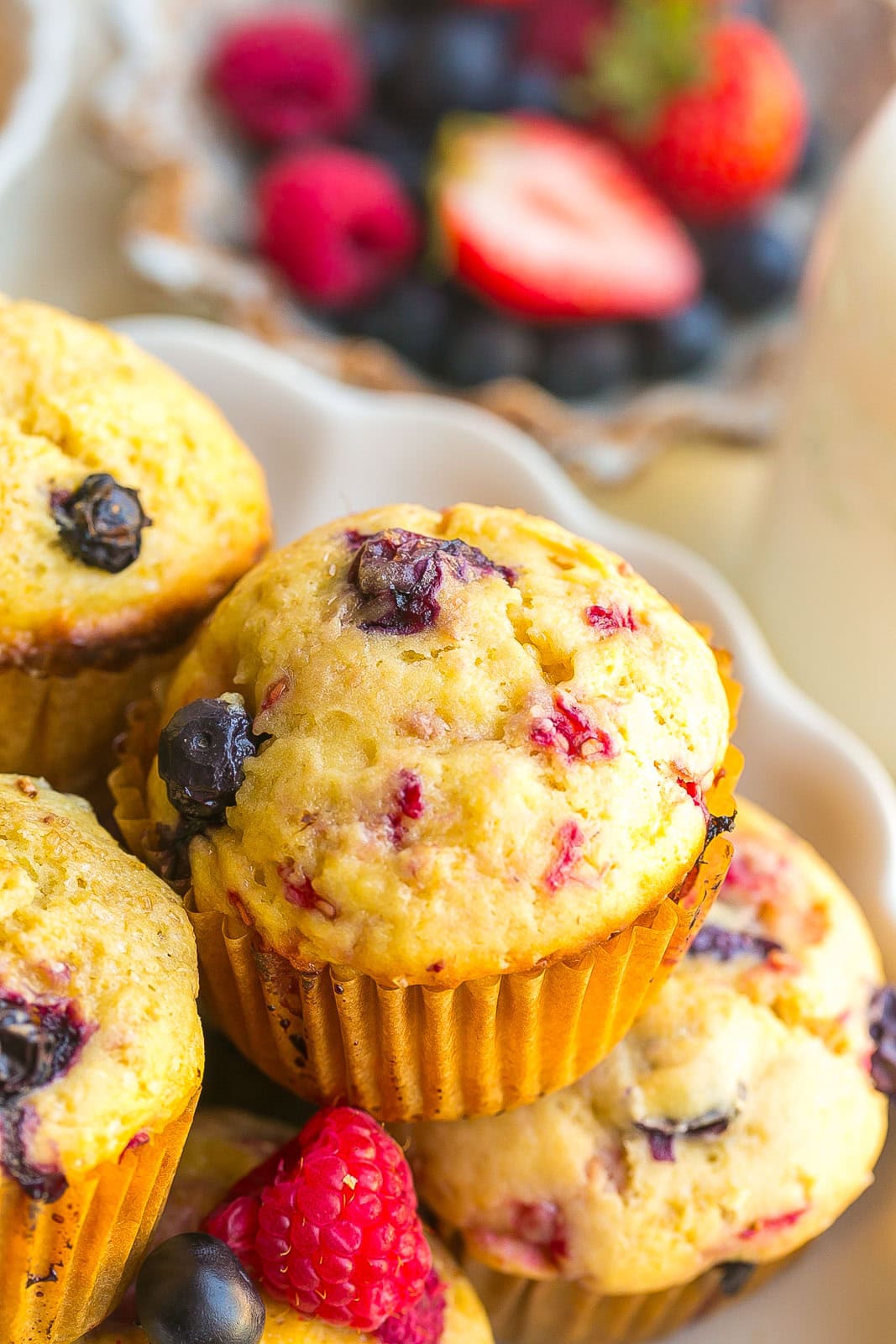 Close-up of a Mixed Berry Muffin showing fresh blueberries, raspberries, and strawberries baked into the tender crumb.
