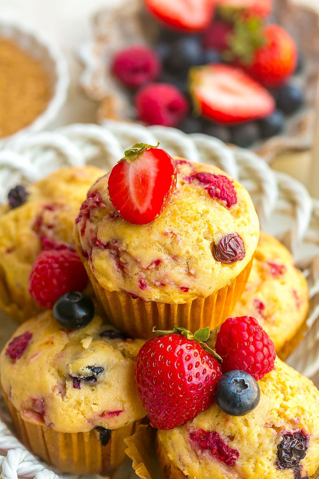 Mixed Berry Muffins packed with fresh berries and golden muffin tops in a bowl.