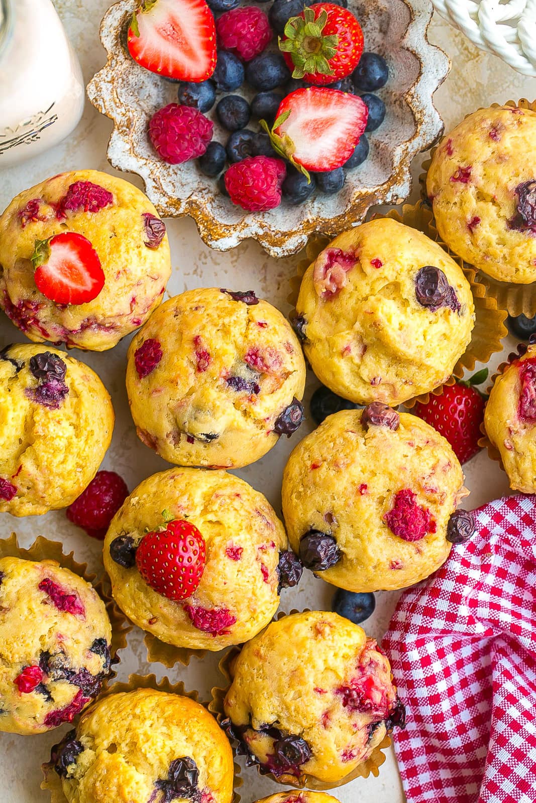Bakery-style Mixed Berry Muffins packed with fresh berries and golden muffin tops.