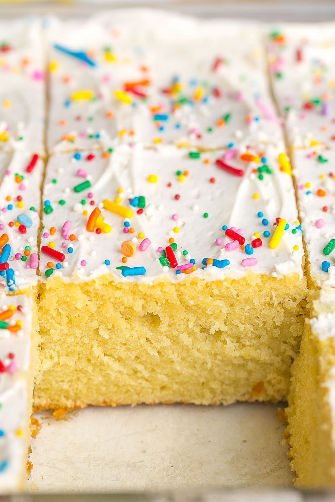Fluffy homemade Vanilla Sheet Cake with rich vanilla buttercream frosting, ready to serve.
