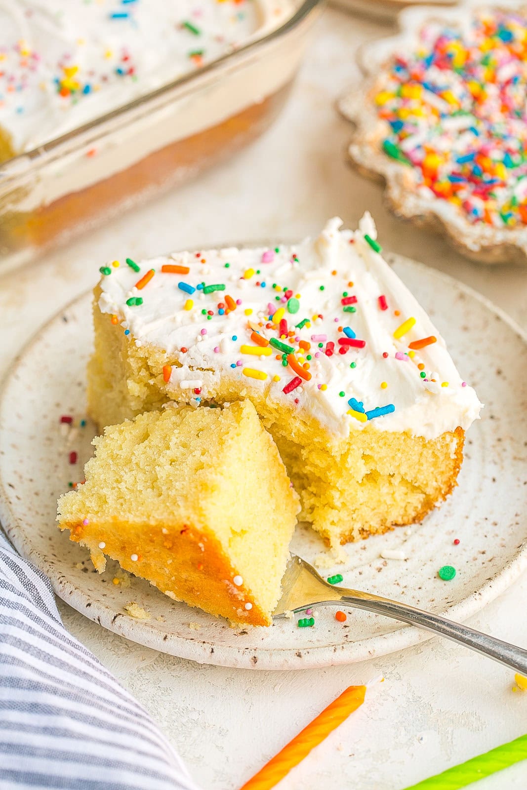 Frosted vanilla cake with fork.