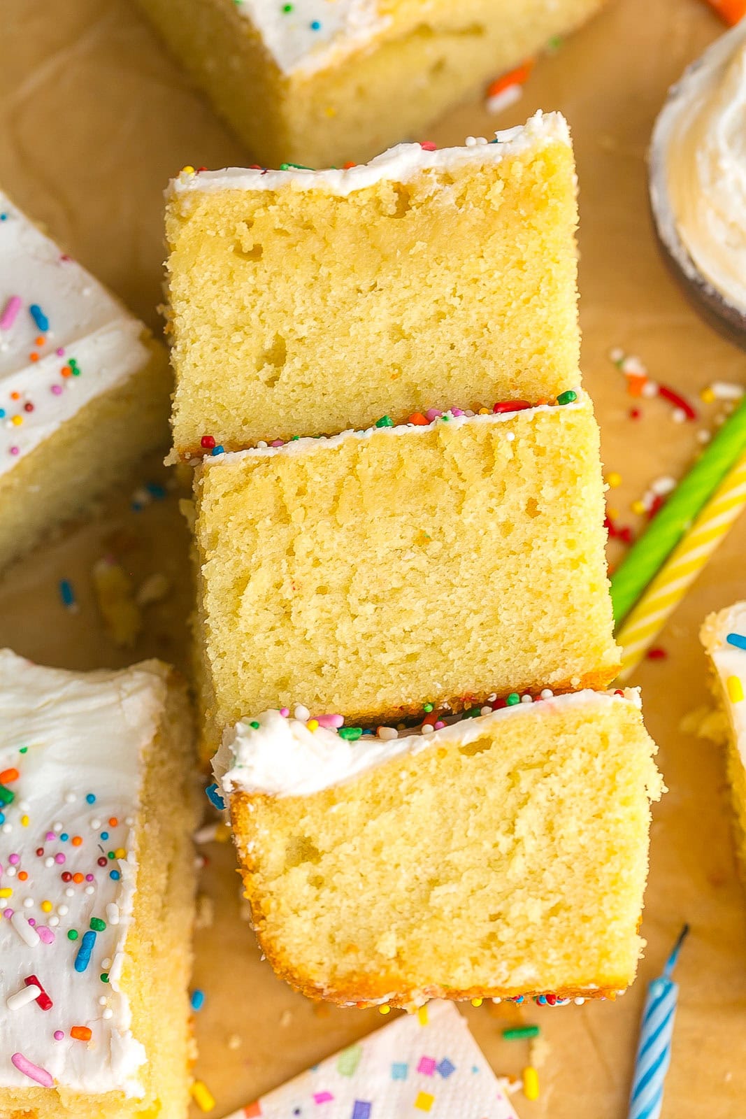Stacked side view of a super moist vanilla cake with buttercream frosting.