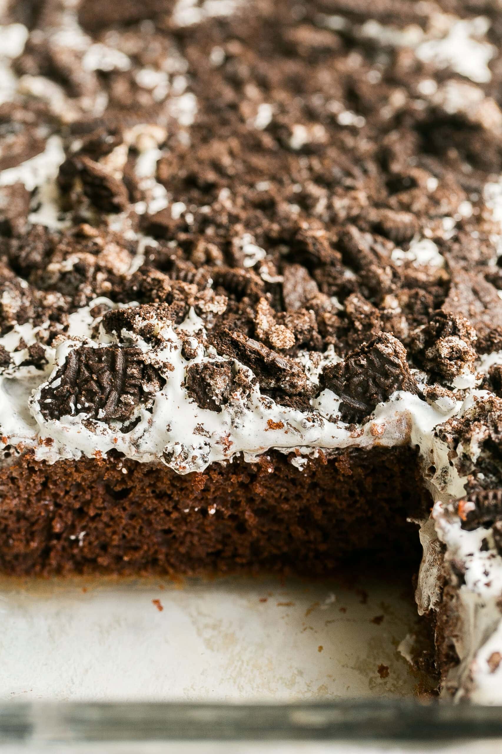 Side view of Oreo Cake with lots of Oreo pieces on top.